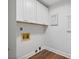 Practical laundry area featuring overhead cabinets and visible utility connections at 50 Stonington Pl, Marietta, GA 30068