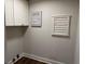 Well-organized laundry area with white cabinets and drying rack, blending style and functionality at 50 Stonington Pl, Marietta, GA 30068