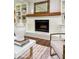 Cozy living room featuring a charming white brick fireplace and wooden mantel at 50 Stonington Pl, Marietta, GA 30068