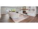 Comfortable living room with fireplace and built-in shelving for storage, plus wood floor and light colors at 50 Stonington Pl, Marietta, GA 30068