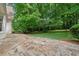 Stunning stone patio provides ample space for outdoor seating, surrounded by lush greenery and trees at 50 Stonington Pl, Marietta, GA 30068