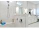 Bright bathroom featuring a white vanity with double sinks, a luxurious shower with a rainfall showerhead, and a marble tile at 719 Elizabeth Trl, Woodstock, GA 30189