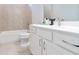 Neutral bathroom featuring a white vanity with a single sink, tile shower with bathtub and toilet at 719 Elizabeth Trl, Woodstock, GA 30189