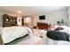 Spacious bedroom featuring a queen size bed, sitting area, bookshelf and television at 719 Elizabeth Trl, Woodstock, GA 30189