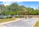 Bocce ball court including shaded seating, beautiful landscaping, and meticulous lawn care at 719 Elizabeth Trl, Woodstock, GA 30189