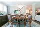 Elegant dining room with a chandelier, classic furniture, and plenty of space for Gathering meals at 719 Elizabeth Trl, Woodstock, GA 30189