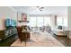 Cozy living room with fireplace, large windows, and comfortable seating, creating a warm atmosphere at 719 Elizabeth Trl, Woodstock, GA 30189
