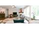 Spacious living room with fireplace, large windows, and comfortable seating, ideal for relaxation at 719 Elizabeth Trl, Woodstock, GA 30189