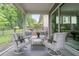Relaxing screened-in patio with comfortable seating area at 719 Elizabeth Trl, Woodstock, GA 30189