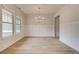 Elegant dining room with wainscoting, light wood floors, neutral paint, and plenty of natural light at 105 Bre Dr, Fayetteville, GA 30215