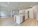 Kitchen island with a stainless steel dishwasher, leading to a living space with fireplace and staircase at 105 Bre Dr, Fayetteville, GA 30215