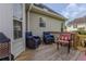 Back deck seating area with chairs, table, and wooded backyard at 1365 Juniper Springs Trl, Loganville, GA 30052