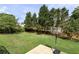 View of backyard with large grassy area and a basketball hoop at 1365 Juniper Springs Trl, Loganville, GA 30052
