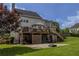 Backyard features a wooden deck, a large concrete pad, lawn and mature trees, offering shade and privacy at 1365 Juniper Springs Trl, Loganville, GA 30052