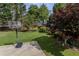 Large grassy backyard with mature trees and a basketball hoop at 1365 Juniper Springs Trl, Loganville, GA 30052