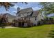 Exterior view of the house with a deck, patio, and large grassy backyard at 1365 Juniper Springs Trl, Loganville, GA 30052