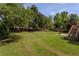 Large grassy backyard with trees and basketball hoop at 1365 Juniper Springs Trl, Loganville, GA 30052