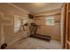 Unfinished basement area with a treadmill and natural light at 1365 Juniper Springs Trl, Loganville, GA 30052