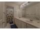 Bathroom featuring double sink vanity with a large mirror, toilet, and shower at 1365 Juniper Springs Trl, Loganville, GA 30052