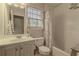 Bright bathroom featuring a vanity with sink, toilet, and shower with curtain at 1365 Juniper Springs Trl, Loganville, GA 30052