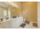 Bathroom with a double vanity, ample counter space, and tile flooring at 1365 Juniper Springs Trl, Loganville, GA 30052