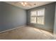 Well-lit bedroom features neutral paint, carpet flooring and a large window at 1365 Juniper Springs Trl, Loganville, GA 30052