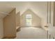 Bright bedroom features a window, carpeted floor, and built-in shelves at 1365 Juniper Springs Trl, Loganville, GA 30052