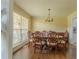 Well-lit dining room features a large window and stylish wood table and chairs at 1365 Juniper Springs Trl, Loganville, GA 30052