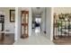 Inviting foyer with neutral tile, showcase cabinet, and views to the living spaces at 1365 Juniper Springs Trl, Loganville, GA 30052