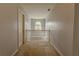Hallway featuring carpet flooring, neutral paint, and a decorative light fixture at 1365 Juniper Springs Trl, Loganville, GA 30052