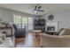 Cozy living room with a fireplace, ceiling fan, and plush seating arrangement at 1365 Juniper Springs Trl, Loganville, GA 30052