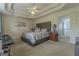 Elegant main bedroom boasts a tray ceiling and an adjoining doorway at 1365 Juniper Springs Trl, Loganville, GA 30052