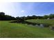 Scenic community pond surrounded by lush green landscaping, offering a peaceful view at 1365 Juniper Springs Trl, Loganville, GA 30052