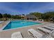 Community swimming pool with lounge chairs and a nearby covered area at 1365 Juniper Springs Trl, Loganville, GA 30052