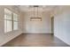 Dining room featuring coffered ceilings, wainscotting and an elegant light fixture at 145 Bre Dr, Fayetteville, GA 30215