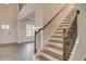 Grand foyer features soaring ceilings, stairway with iron spindles, and white painted wainscotting at 145 Bre Dr, Fayetteville, GA 30215