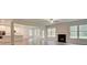 Open-concept living room with modern fireplace and bright windows overlooking the backyard at 145 Bre Dr, Fayetteville, GA 30215