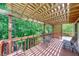 Inviting back porch with a wooden pergola, offering shade and a relaxing outdoor space at 2285 Ashton Ridge Dr, Dacula, GA 30019