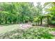 Landscaped backyard featuring an arbor, ideal for outdoor gatherings at 2285 Ashton Ridge Dr, Dacula, GA 30019