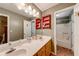 Full bathroom boasting double sinks, a large mirror, and built-in storage shelves at 2285 Ashton Ridge Dr, Dacula, GA 30019