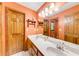 Well-lit bathroom featuring a large mirror, double vanity, and multiple doors at 2285 Ashton Ridge Dr, Dacula, GA 30019
