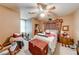 Comfortable bedroom featuring a ceiling fan, area rug, and rocking chair at 2285 Ashton Ridge Dr, Dacula, GA 30019