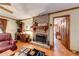 Cozy living room area with brick fireplace, hardwood floors, and comfortable seating at 2285 Ashton Ridge Dr, Dacula, GA 30019