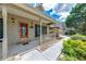 Cozy front porch with a red door, decorative lights, and manicured landscaping at 2285 Ashton Ridge Dr, Dacula, GA 30019