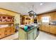Well-lit kitchen featuring a center island with dark countertops and wooden cabinetry at 2285 Ashton Ridge Dr, Dacula, GA 30019