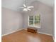 Bright bedroom featuring hardwood floors, high ceilings, and a ceiling fan at 445 Royal St, Mcdonough, GA 30253