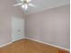 Bedroom showcasing hardwood floors, neutral walls, and a double door closet at 445 Royal St, Mcdonough, GA 30253