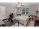 Well-lit bedroom featuring a ceiling fan, window, and neutral color palette at 445 Royal St, Mcdonough, GA 30253