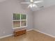 Bedroom featuring hardwood floors, neutral walls, and a backyard view at 445 Royal St, Mcdonough, GA 30253