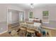 Comfortable dining room featuring natural light, a stylish chandelier, and views to the entryway at 445 Royal St, Mcdonough, GA 30253